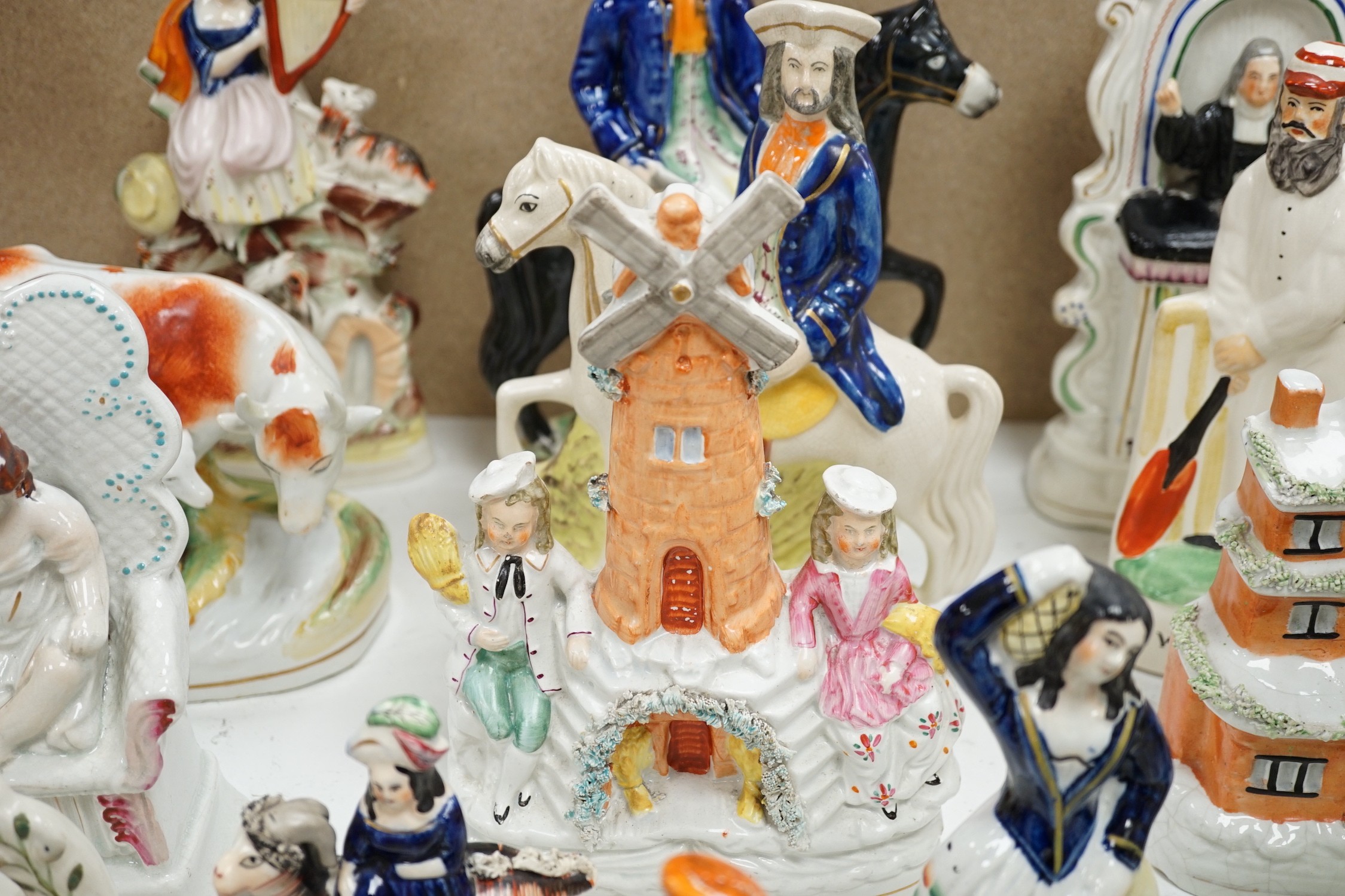 A collection of Victorian Staffordshire pottery flat-back figures and groups, tallest 29cm